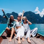 three-woman-tourists-friends-travel-around-khao-sok-national-park-vacation-thailand-sailing-asian-boat-lake-sunny-day-with-amazing-view